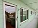 View down a hallway with a light green wall and a door to a condo at 2043 Denmark St # 57, Clearwater, FL 33763