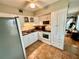 Kitchen with white cabinets, stainless steel appliances, and tile floors at 2043 Denmark St # 57, Clearwater, FL 33763