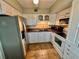 Kitchen with white cabinets, stainless steel appliances, and tile floors at 2043 Denmark St # 57, Clearwater, FL 33763