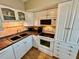 Kitchen with white cabinets, stainless steel appliances, and tile floors at 2043 Denmark St # 57, Clearwater, FL 33763