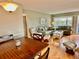 Living room with hardwood floors, couches, and a dining table at 2043 Denmark St # 57, Clearwater, FL 33763