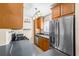 Full kitchen view, showcasing stainless steel refrigerator and cabinetry at 1101 Victoria Dr # 16, Dunedin, FL 34698