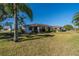Single-story home with red tile roof and large backyard at 1207 Bluewater Dr, Sun City Center, FL 33573