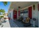 Relaxing front porch with rocking chairs and red shutters at 1207 Bluewater Dr, Sun City Center, FL 33573