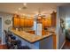 Kitchen with wood cabinets, granite counters, and breakfast bar at 1207 Bluewater Dr, Sun City Center, FL 33573