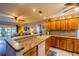 Kitchen features wood cabinets and granite countertops at 1207 Bluewater Dr, Sun City Center, FL 33573