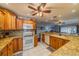 Kitchen with white appliances and wood cabinets at 1207 Bluewater Dr, Sun City Center, FL 33573