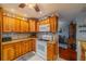 Kitchen with wood cabinets and a large island at 1207 Bluewater Dr # 17, Sun City Center, FL 33573