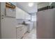 Bright laundry room with washer, dryer, and storage at 1207 Bluewater Dr, Sun City Center, FL 33573
