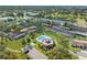 Condo community with pool, lush landscaping, and parking at 12200 Vonn Rd # 1106, Largo, FL 33774
