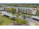 Condo building with parking and surrounding landscape at 12200 Vonn Rd # 1106, Largo, FL 33774