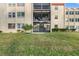 Building exterior with screened patio and grassy area at 12200 Vonn Rd # 1106, Largo, FL 33774
