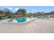 Inviting community pool with surrounding lounge chairs at 12200 Vonn Rd # 1106, Largo, FL 33774