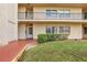 Condo building entrance with lush landscaping and walkway at 12200 Vonn Rd # 1106, Largo, FL 33774
