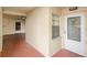 Condo building entrance with elevator access and welcoming door at 12200 Vonn Rd # 1106, Largo, FL 33774