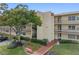 Two-story condo building with balconies and landscaping at 12200 Vonn Rd # 1106, Largo, FL 33774
