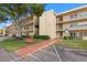 Two-story condo building with landscaping and accessible entrance at 12200 Vonn Rd # 1106, Largo, FL 33774