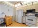 Kitchen with wood cabinets and white appliances at 12200 Vonn Rd # 1106, Largo, FL 33774