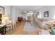 Living room with hardwood floors and view to kitchen at 12200 Vonn Rd # 1106, Largo, FL 33774