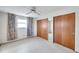 Bedroom with window, ceiling fan and sliding closet doors at 12400 Park Blvd # 118, Seminole, FL 33772