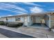 Exterior view of building with carport and landscaping at 12400 Park Blvd # 118, Seminole, FL 33772