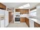 Kitchen with wood cabinets and appliances at 12400 Park Blvd # 118, Seminole, FL 33772