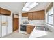 Bright kitchen featuring wood cabinets, gas range, and refrigerator at 12400 Park Blvd # 118, Seminole, FL 33772