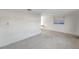 Spacious living room with light-colored flooring and large window at 12400 Park Blvd # 118, Seminole, FL 33772