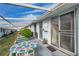 Relaxing patio with table and chairs, adjacent to building at 12400 Park Blvd # 118, Seminole, FL 33772