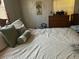 Bedroom with a double bed, wooden dresser, and patterned bedding at 12501 Ulmerton Rd # 140, Largo, FL 33774