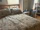 Cozy bedroom with a double bed and wood nightstand at 12501 Ulmerton Rd # 140, Largo, FL 33774