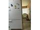 Kitchen with white refrigerator and view into sunroom at 12501 Ulmerton Rd # 140, Largo, FL 33774