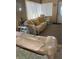 Living room with floral sofas and yellow pillows at 12501 Ulmerton Rd # 140, Largo, FL 33774