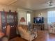 Relaxing living room with recliner, TV, and wood flooring at 12501 Ulmerton Rd # 140, Largo, FL 33774