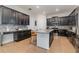Spacious kitchen with dark cabinetry, granite counters, and an island at 13513 White Sapphire Rd, Riverview, FL 33579