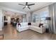 Open living room with white sectional sofa and view into kitchen and dining area at 13513 White Sapphire Rd, Riverview, FL 33579