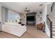 Living room with white sectional sofa, fireplace, and built-in shelving at 13513 White Sapphire Rd, Riverview, FL 33579