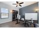 Home office with a large desk, multiple monitors, and a bookshelf at 13513 White Sapphire Rd, Riverview, FL 33579