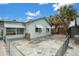 Light green house with a spacious backyard and chain link fence at 137 91St Ave, Treasure Island, FL 33706