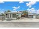 Light green house with a small front yard and a detached garage at 137 91St Ave, Treasure Island, FL 33706