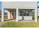 Covered patio with brick pavers and double doors at 14115 Indigo Ridge Ln, Lithia, FL 33547