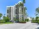 Condo building with parking and tropical landscaping at 1600 Gulf Blvd # 213, Clearwater Beach, FL 33767