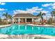 Inviting community pool with a curved design and plenty of lounge chairs at 16023 10Th E Ave, Bradenton, FL 34212