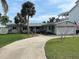 Charming house with a paved driveway and lush landscaping at 1643 Sea Breeze Dr, Tarpon Springs, FL 34689