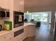 Modern kitchen with stainless steel appliances and views to living room at 1643 Sea Breeze Dr, Tarpon Springs, FL 34689