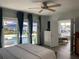 Bright main bedroom with water views, sliding doors to pool area, and ample closet space at 1643 Sea Breeze Dr, Tarpon Springs, FL 34689