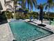 Sparkling pool with patio furniture and umbrella at 1643 Sea Breeze Dr, Tarpon Springs, FL 34689