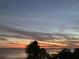 Stunning sunset view over the calm water at 1643 Sea Breeze Dr, Tarpon Springs, FL 34689
