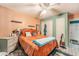 Cozy bedroom with orange bedding and a dresser at 1709 Happy Acres Ln, Valrico, FL 33594