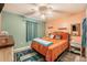 Cozy bedroom with orange bedding and wood-look flooring at 1709 Happy Acres Ln, Valrico, FL 33594